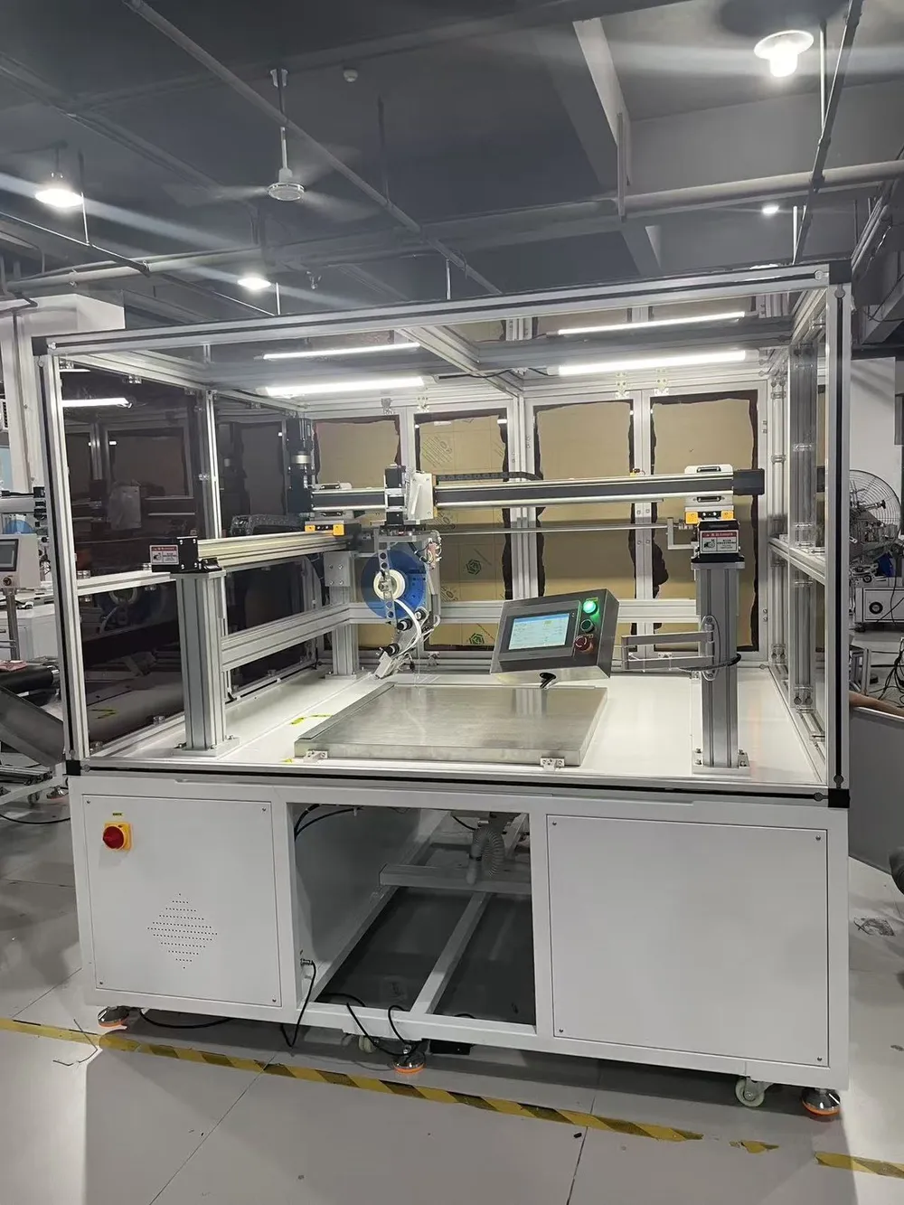 Floor-Standing 3-Axis Tape Applicator — Floor-standing 3-axis tape applicator with safety enclosure