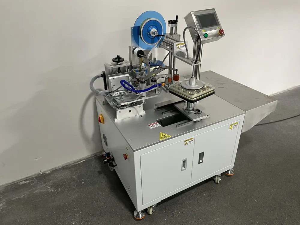 Square Box Tape Applicator — Pneumatic clamps around the box fixture