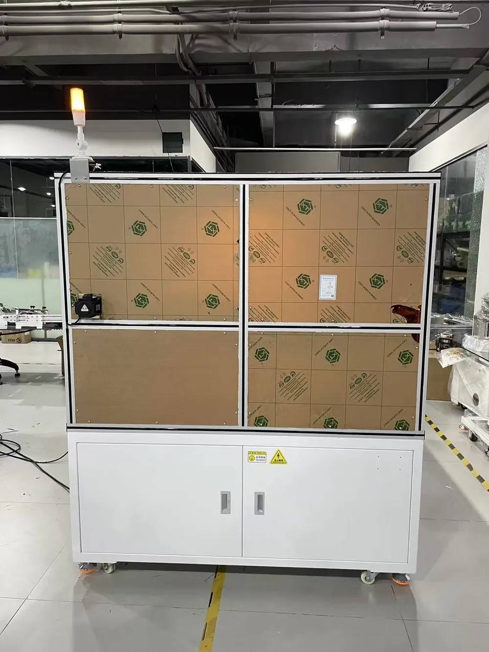 Floor-Standing 3-Axis Tape Applicator — Side of the enclosure, panels still in protective film