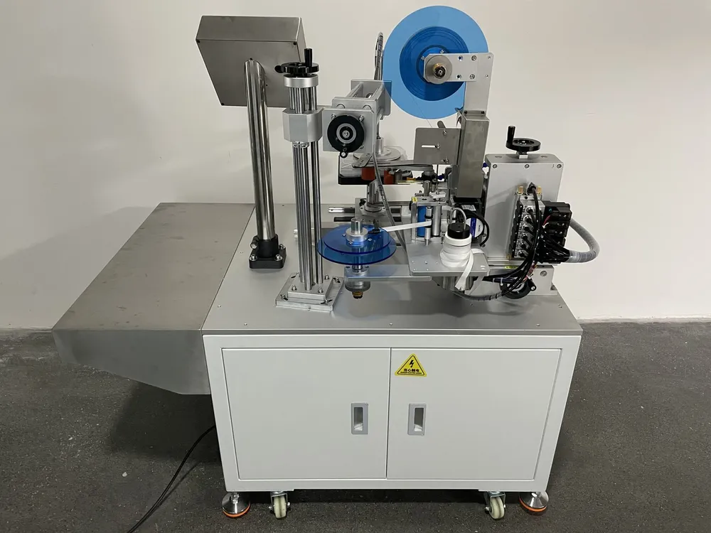 Square Box Tape Applicator — Side view: rotating fixture and tape feed