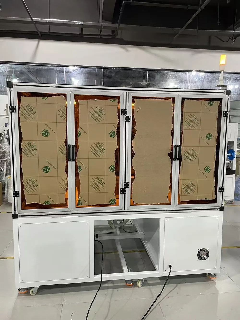 Floor-Standing 3-Axis Tape Applicator — Front doors of the enclosure