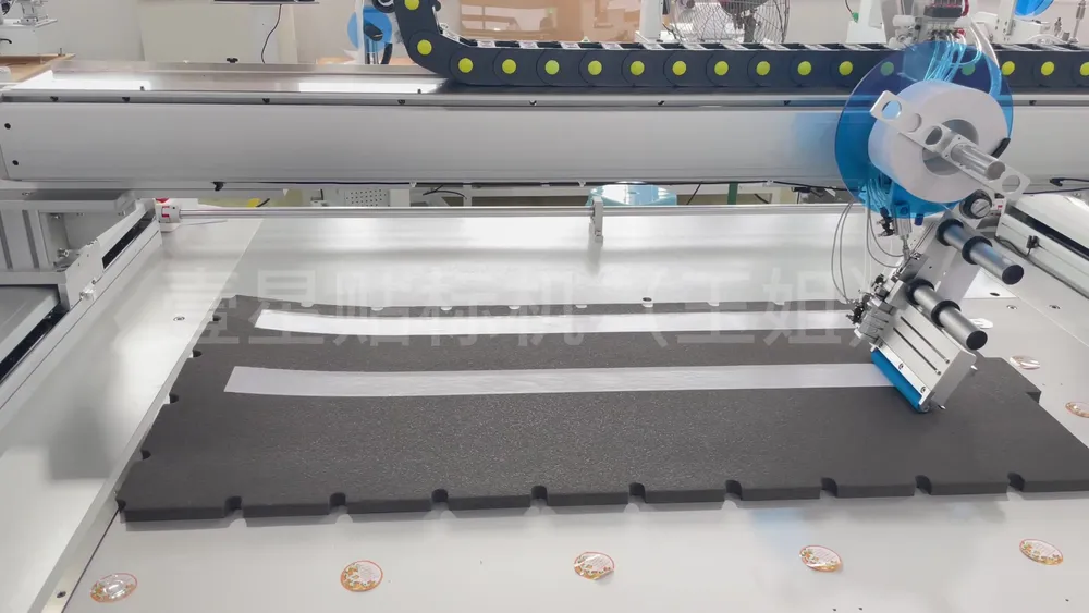 Floor-Standing 3-Axis Tape Applicator — Similar configuration — factory demo still