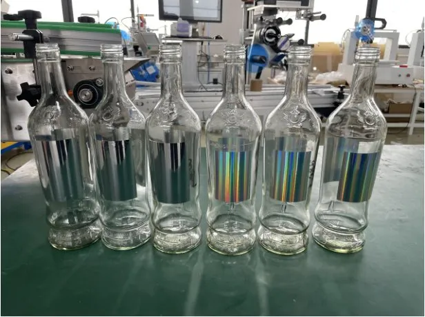 Semi-Automatic Rotary Multi-Face Labeling Machine — Glass bottles with holographic labels
