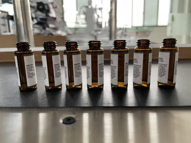 Automatic Horizontal Round Bottle Labeling Machine — Oral liquid vials with labels