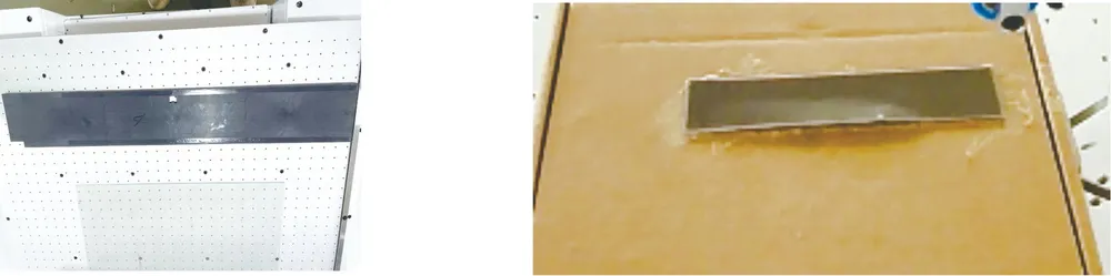 Floor-Standing Rotary-Platform Tape Applicator with Liner Peeling — Taping samples: a strip part on the vacuum table and a cardboard part