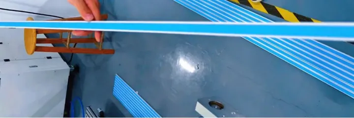 Inline Conveyor Tape Applicator — Long plastic strips with tape applied