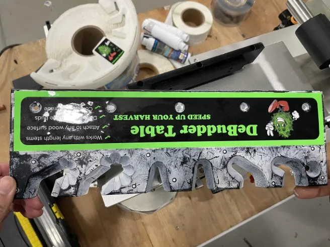 Semi-Automatic Front-and-Back Roll-On Labeling Machine — Large, long label applied by rolling