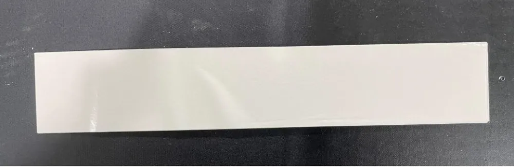 Inline Conveyor Tape Applicator — Flat strip-shaped part with tape applied
