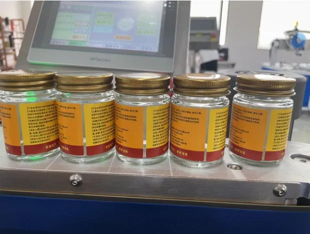 Automatic Roll-Rubbing Wrap-Around Labeling Machine — Glass jars with wrap-around labels