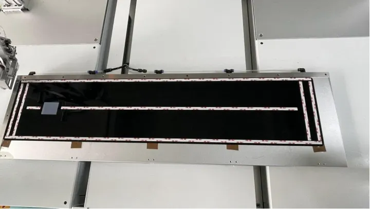 Floor-Standing 3-Axis Tape Applicator — Tape applied along the outline of a panel
